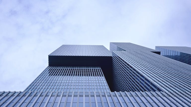 Low-angle view of a modern skyscraper in Rotterdam showcasing futuristic glass architecture.